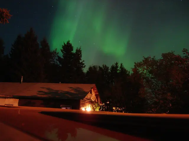 Northern lights over a cabin at Chitek Lake
